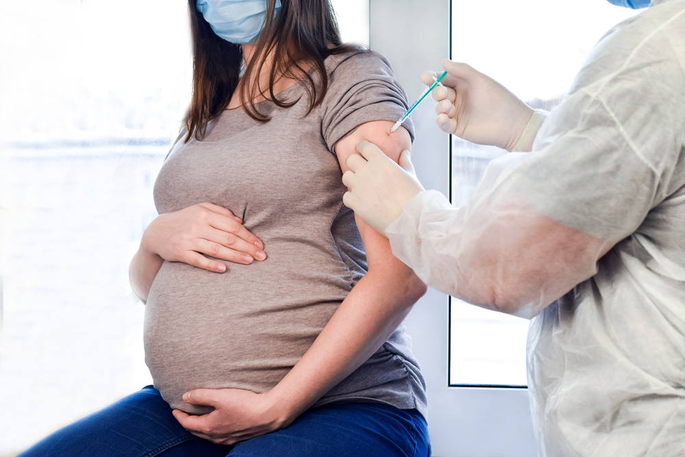Pregnant woman getting COVID Vaccine.