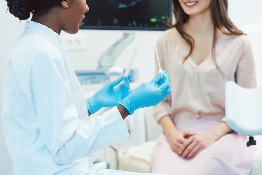 Woman seeing gynecologist doctor in her office to check for STD.