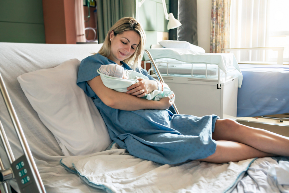 woman holding baby after birth.
