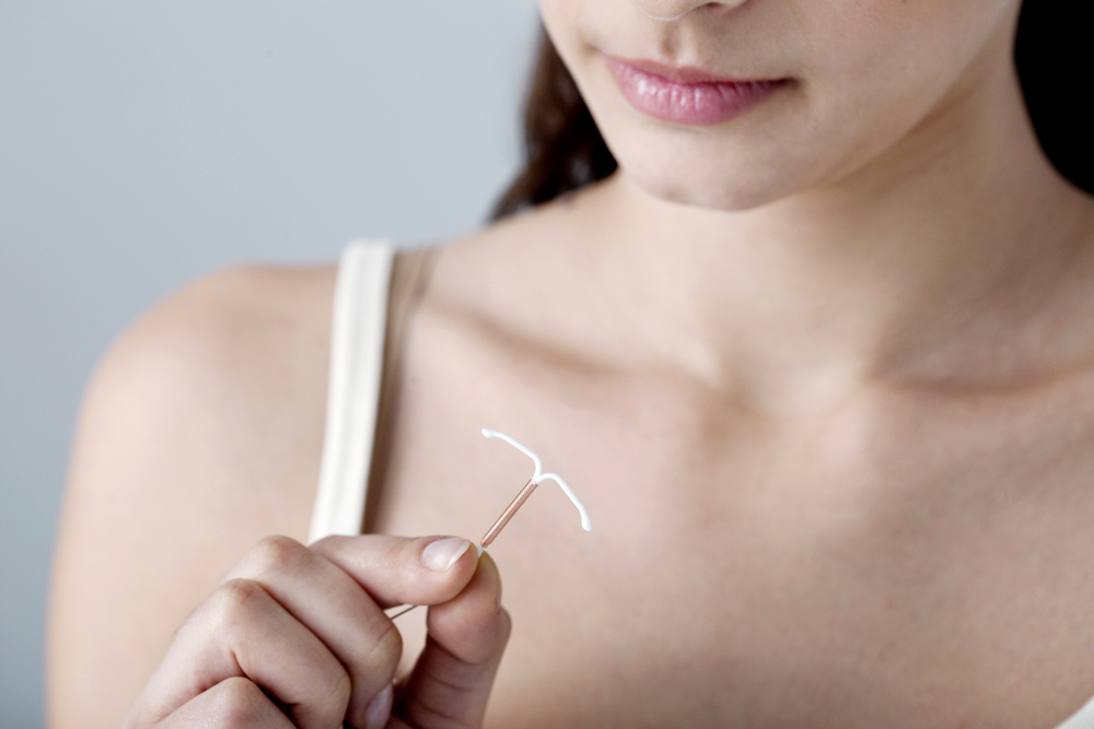 woman holding iud.