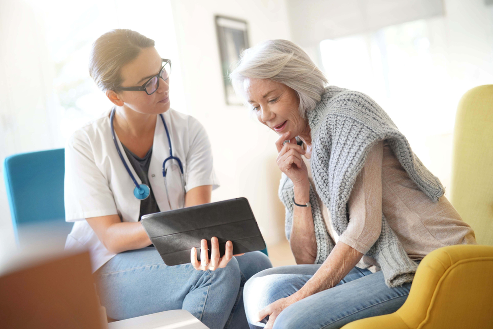 Woman discussing postmenopausal bleeding with doctor.