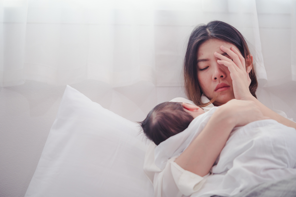 woman upset holding baby.