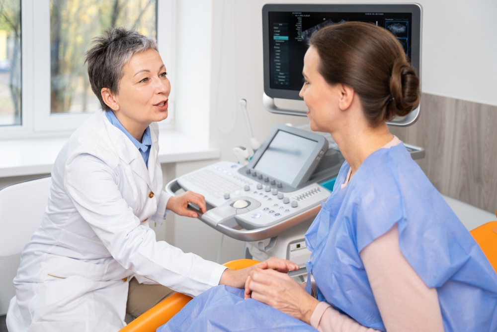 A doctor and patient converse during an appointment.